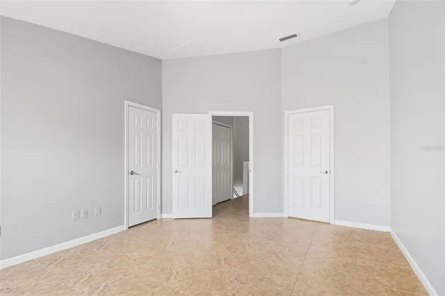 a view of an empty room and closet area