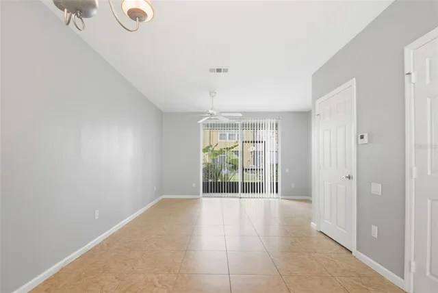a view of an empty room with glass door