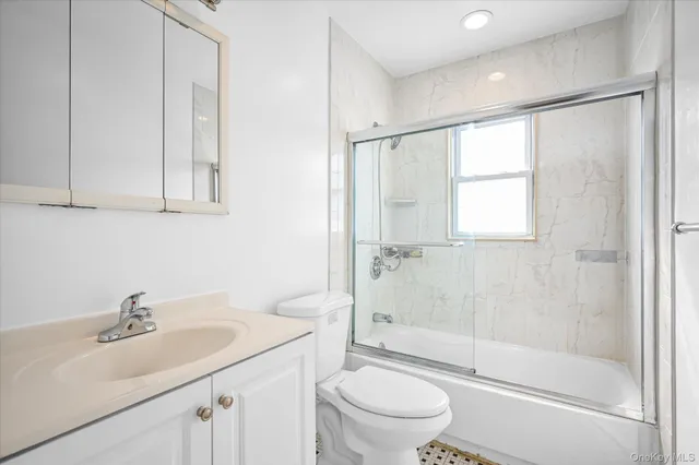 a bathroom with a sink toilet a mirror and shower