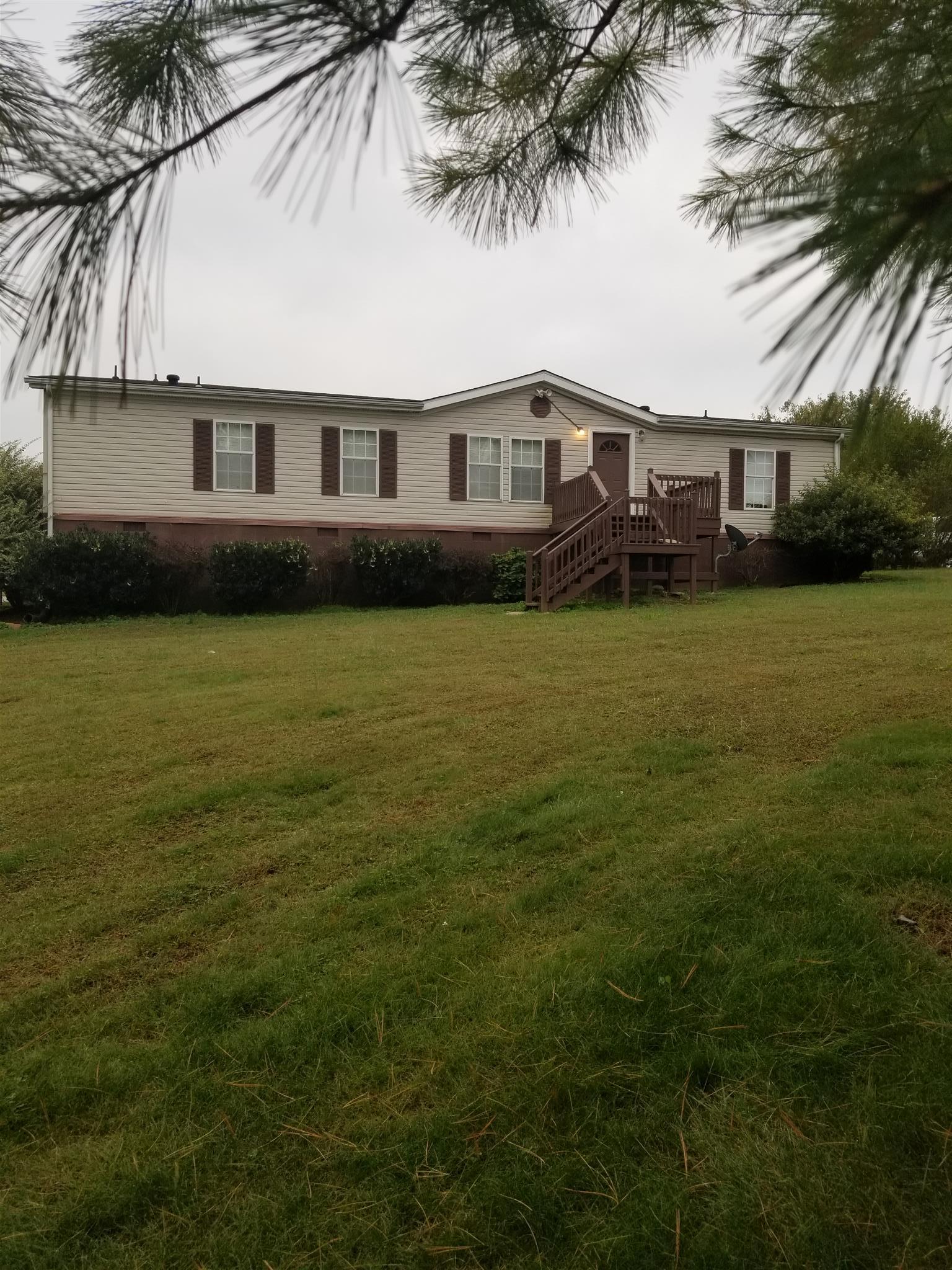 230 Hester Road Portland, TN 37148 - Photo 1 of 4 a front view of a house with a garden