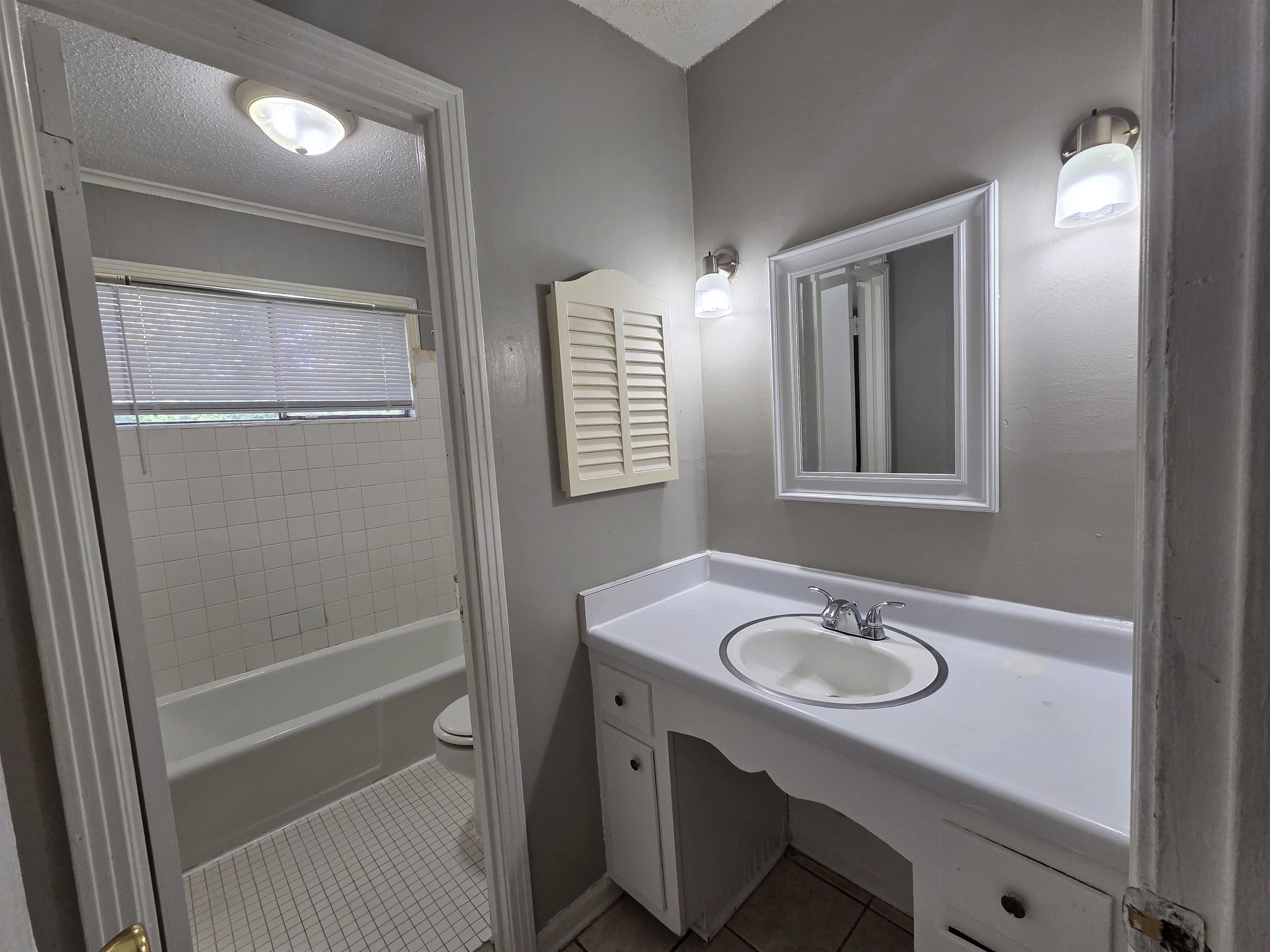 4573 Appleville Street Memphis, TN 38109 - Photo 16 of 22 Full bath with light tile patterned floors, vanity, a textured ceiling, and bathing tub / shower combination