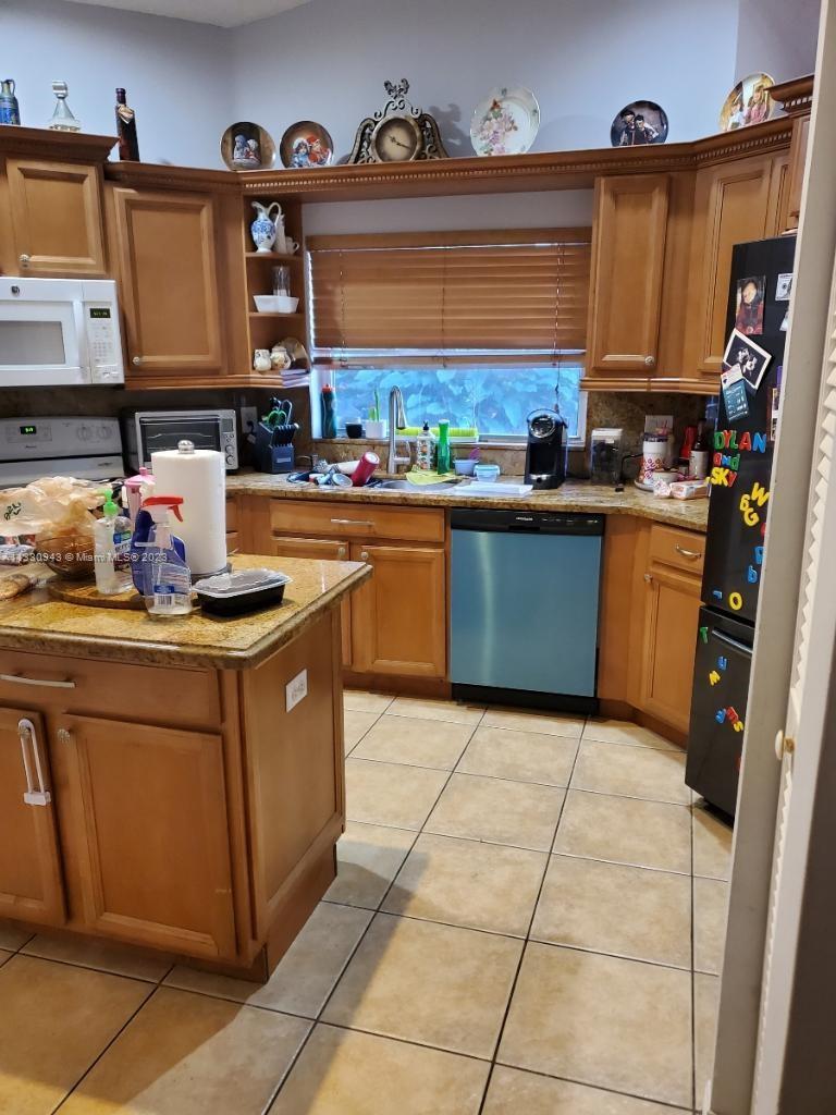 Davie Davie, FL 33325 - Photo 10 of 13 a kitchen with stainless steel appliances granite countertop a sink and cabinets