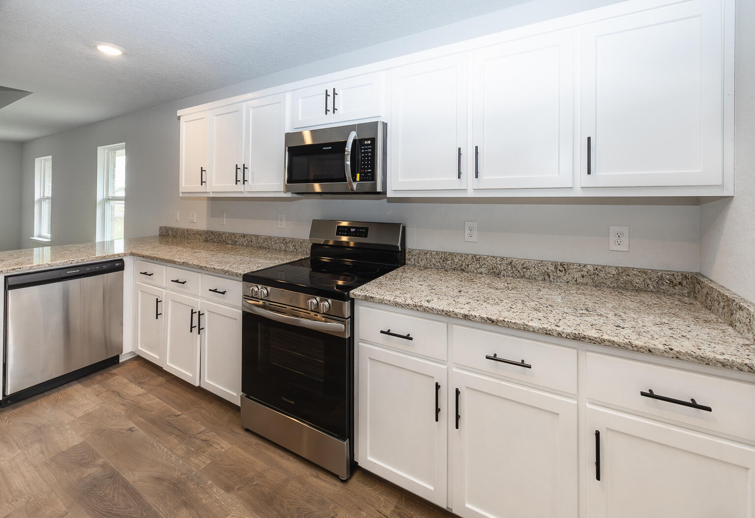 5303 Zenith Lane Milton, FL 32583 - Photo 6 of 21 a kitchen with granite countertop white cabinets and white appliances