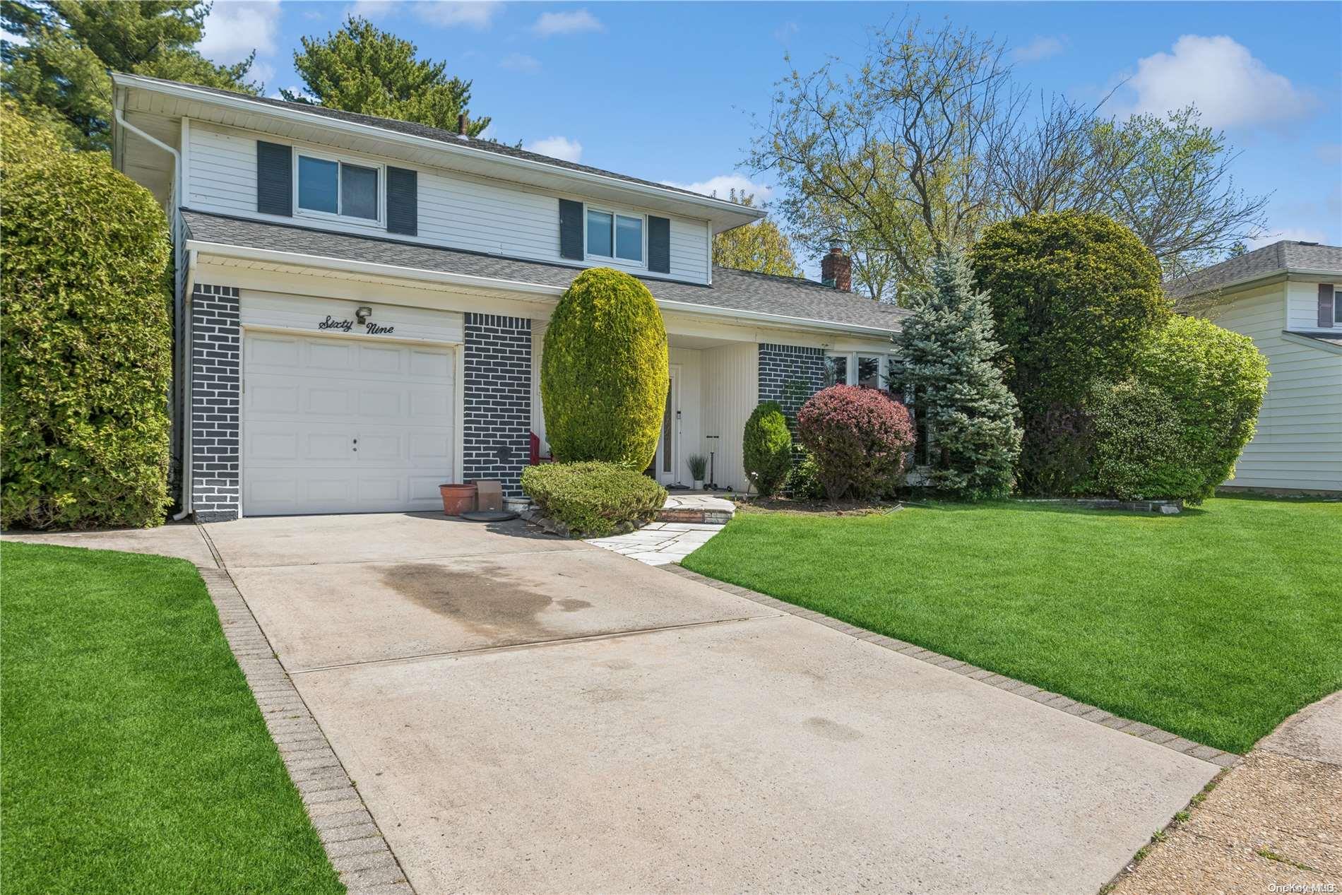 69 Sunnyside Lane Oyster Bay, NY 11590 - Photo 1 of 1 a front view of a house with garden
