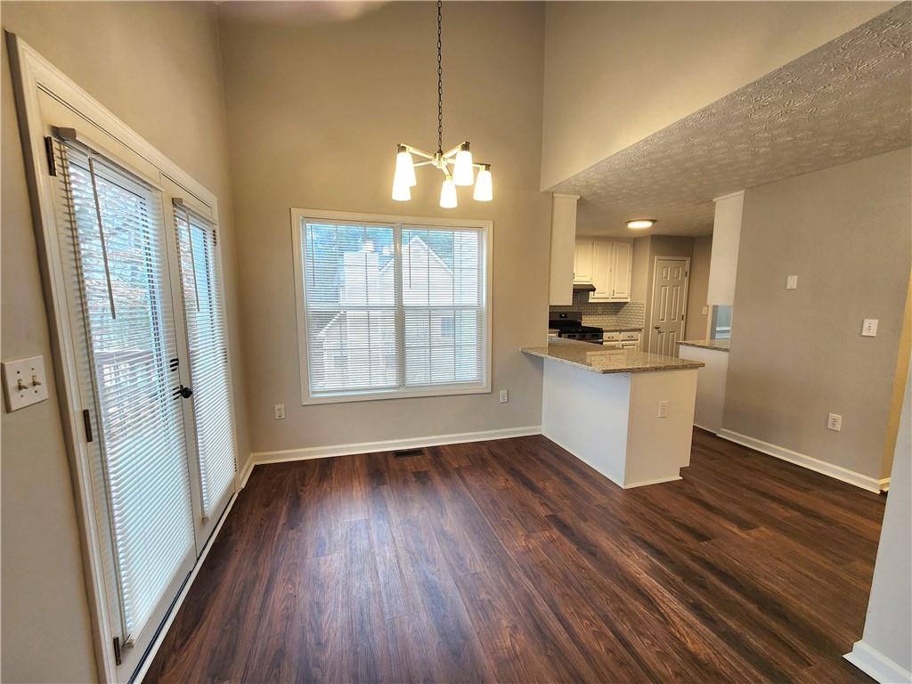 1645 Rushing River Way Suwanee, GA 30024 - Photo 13 of 38 a view of an empty room with window and wooden floor