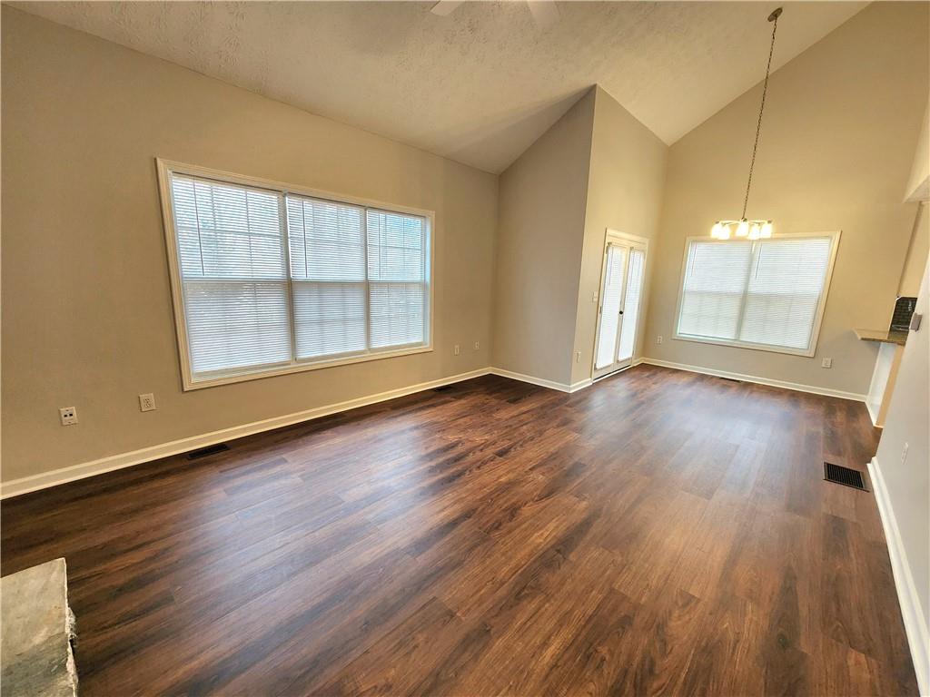 1645 Rushing River Way Suwanee, GA 30024 - Photo 14 of 38 an empty room with wooden floor and windows