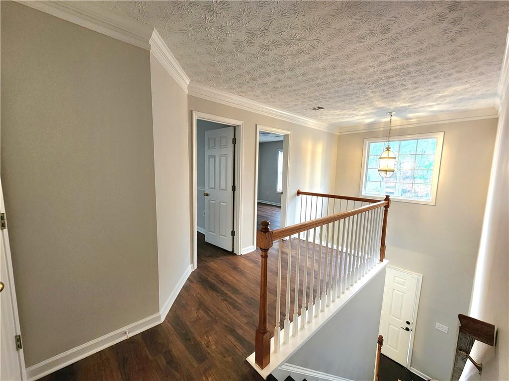 1645 Rushing River Way Suwanee, GA 30024 - Photo 20 of 38 a view of a hallway with wooden floor and windows