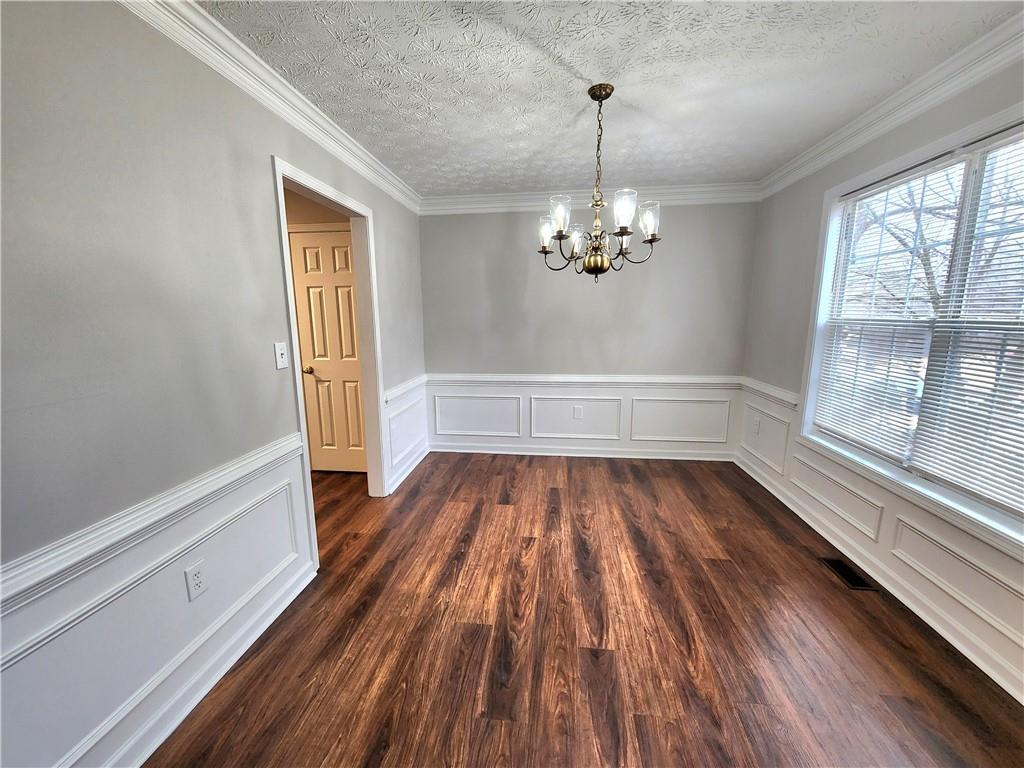 1645 Rushing River Way Suwanee, GA 30024 - Photo 2 of 38 a view of empty room with wooden floor and fan