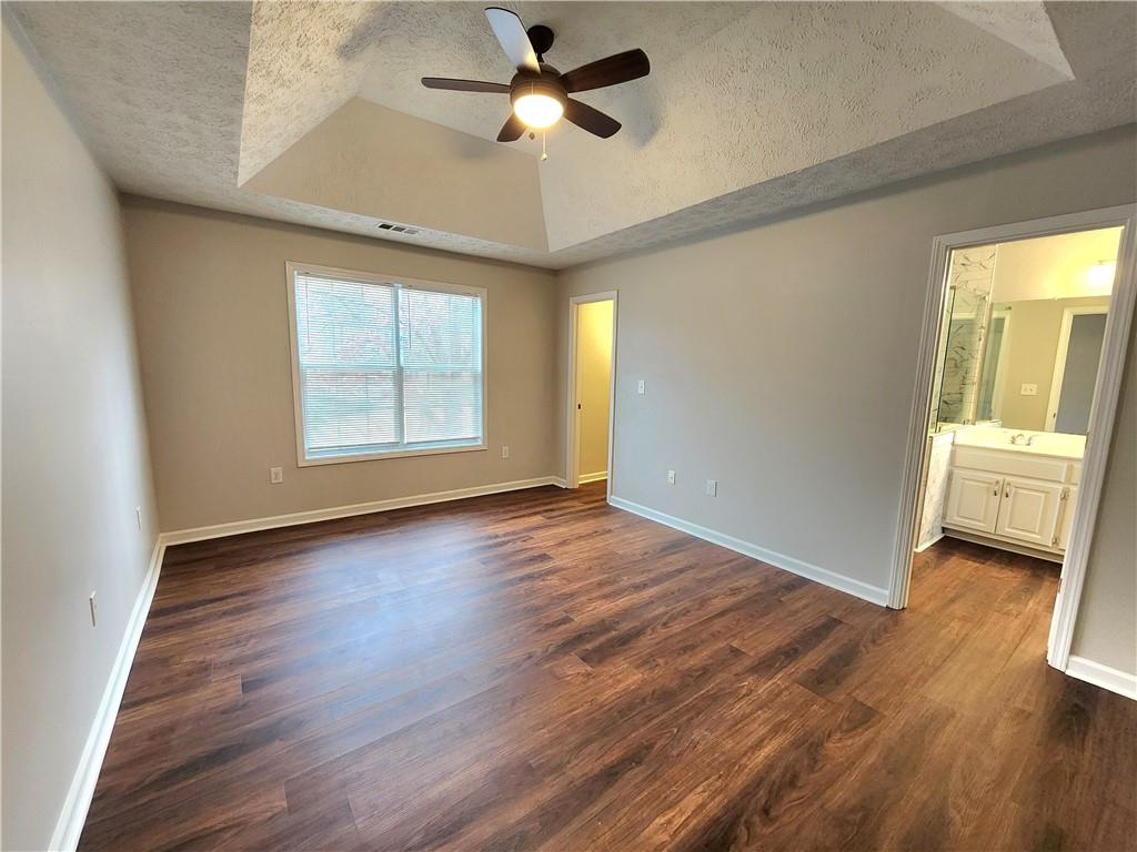 1645 Rushing River Way Suwanee, GA 30024 - Photo 23 of 38 an empty room with wooden floor fan and windows