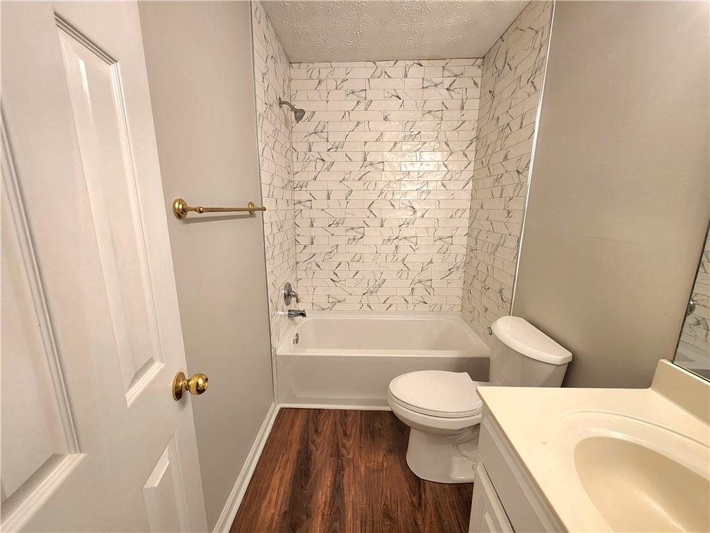 1645 Rushing River Way Suwanee, GA 30024 - Photo 29 of 38 a bathroom with a toilet and a bathtub