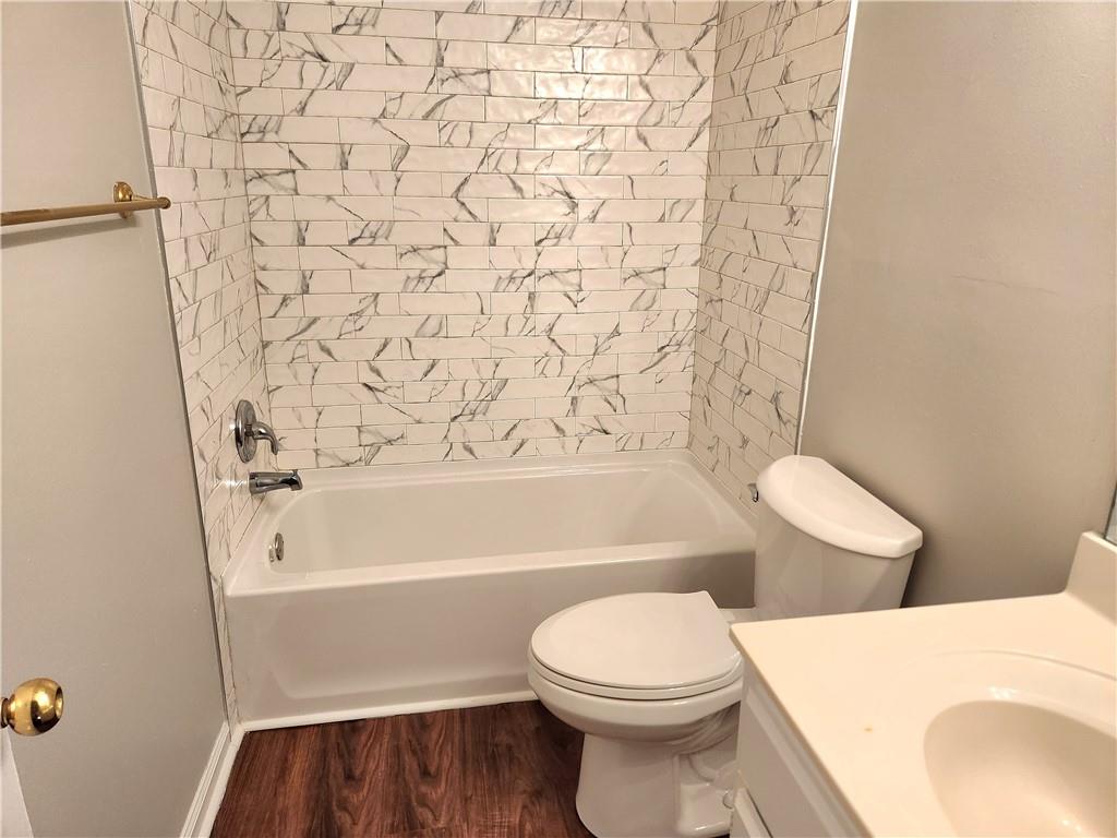 1645 Rushing River Way Suwanee, GA 30024 - Photo 30 of 38 a bathroom with a toilet and a bathtub