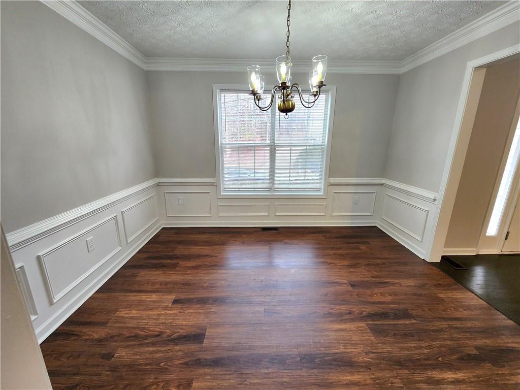 1645 Rushing River Way Suwanee, GA 30024 - Photo 3 of 38 a view of empty room with wooden floor and fan