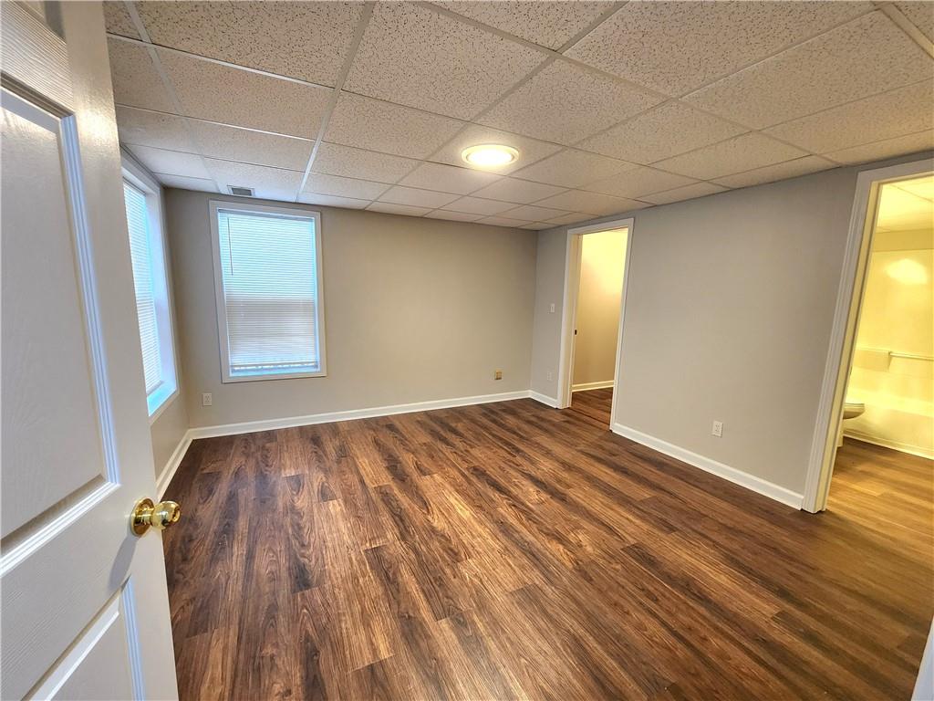 1645 Rushing River Way Suwanee, GA 30024 - Photo 31 of 38 an empty room with wooden floor and windows
