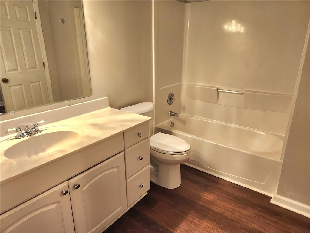1645 Rushing River Way Suwanee, GA 30024 - Photo 32 of 38 a bathroom with a sink a toilet and shower