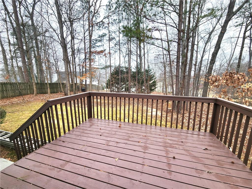 1645 Rushing River Way Suwanee, GA 30024 - Photo 35 of 38 a balcony with wooden floor and trees