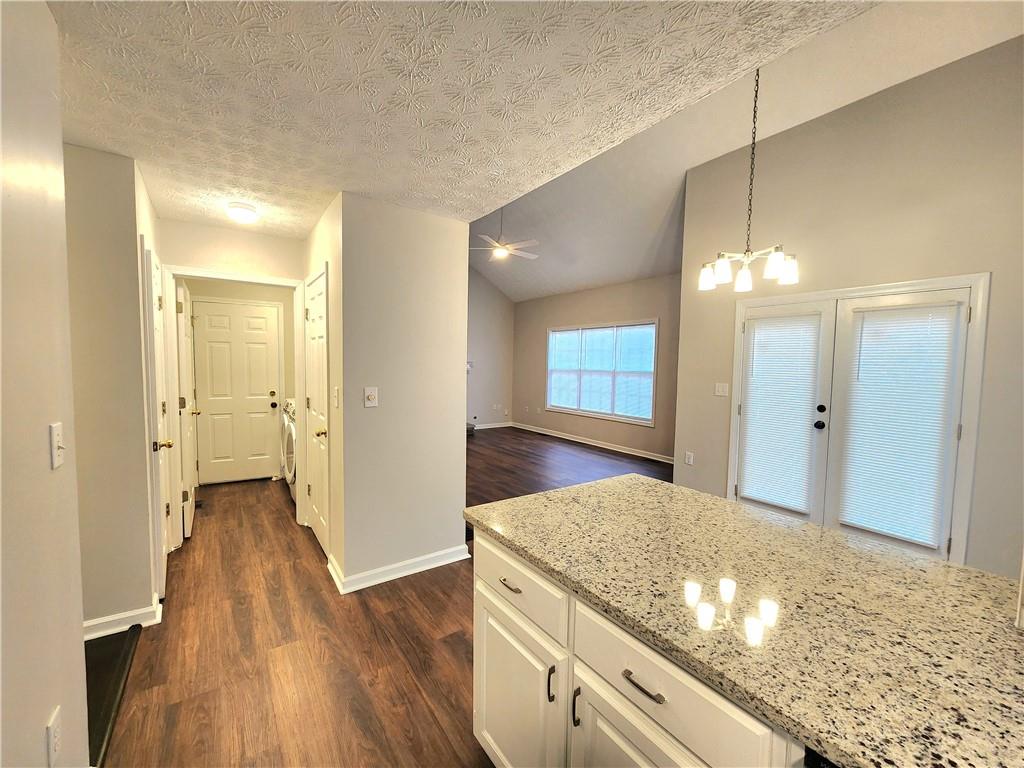 1645 Rushing River Way Suwanee, GA 30024 - Photo 9 of 38 a view of a kitchen cabinets and wooden floor