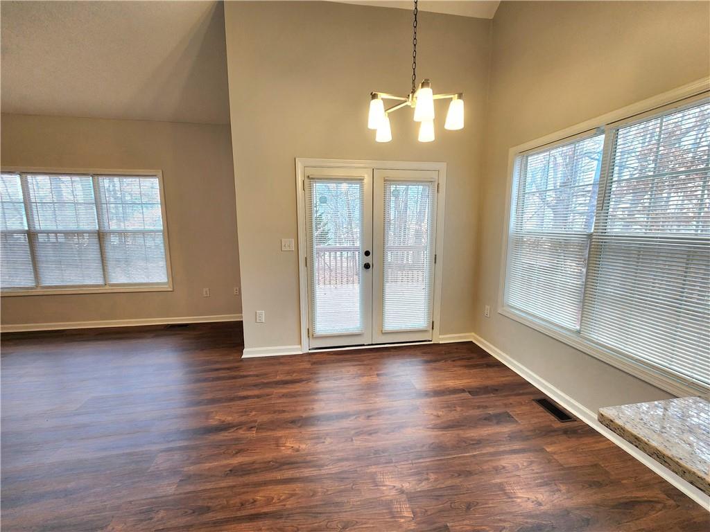 1645 Rushing River Way Suwanee, GA 30024 - Photo 10 of 38 an empty room with wooden floor and windows