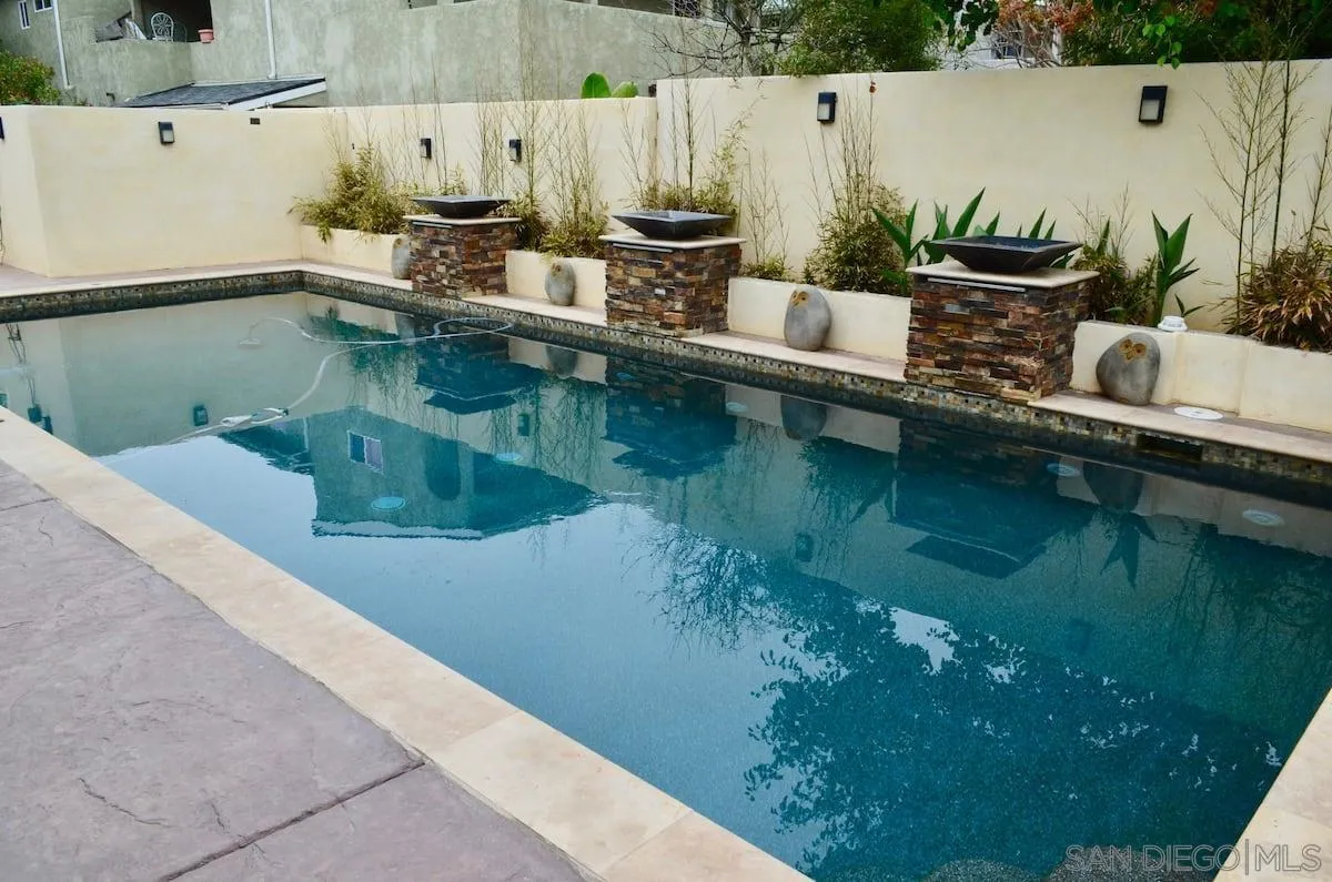 1235 Neptune Avenue Encinitas, CA 92024 - Photo 22 of 32 a view of a swimming pool with a yard