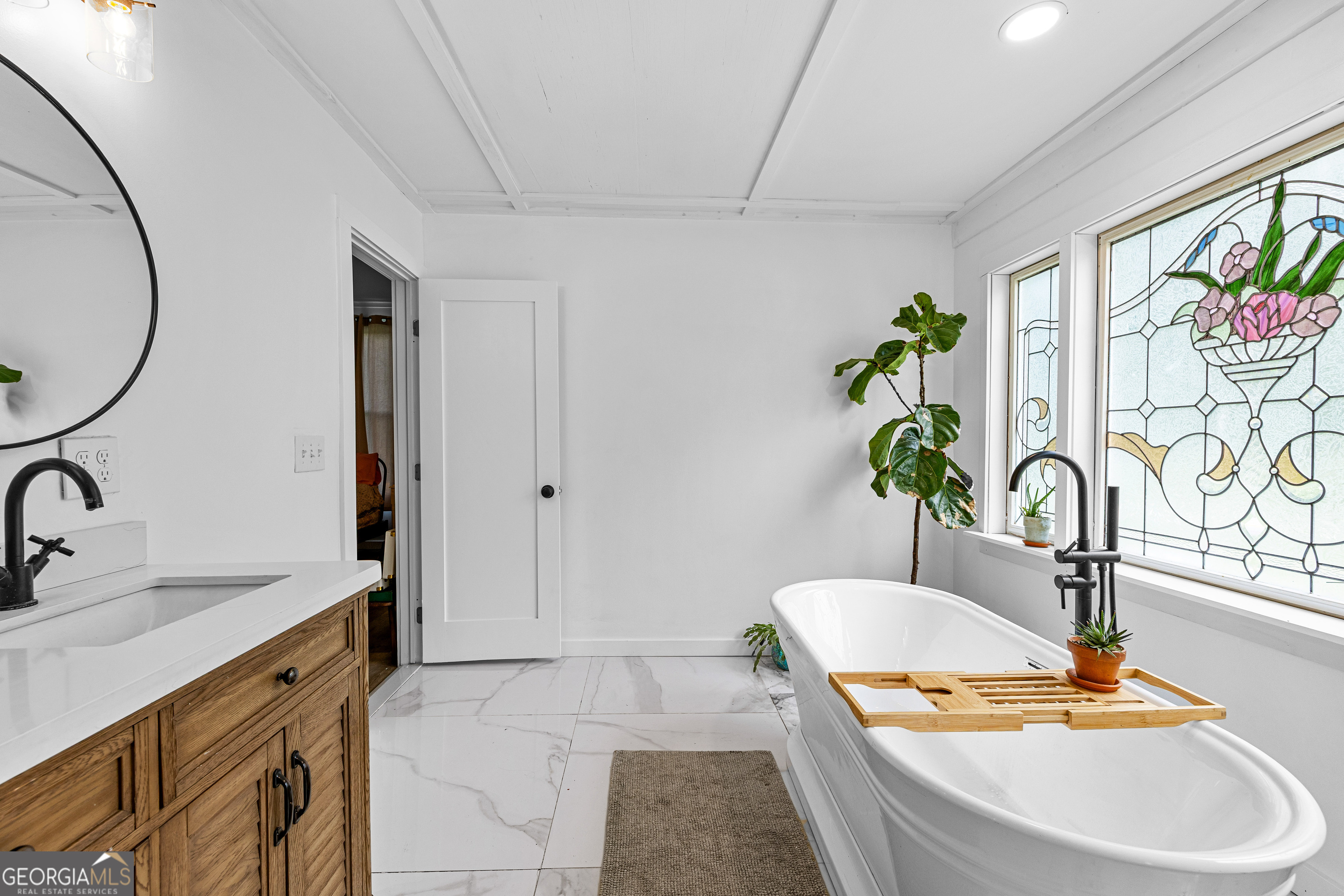 1329 Standing Rock Road Senoia, GA 30276 - Photo 36 of 77 a bathroom with a granite countertop sink a toilet and mirror