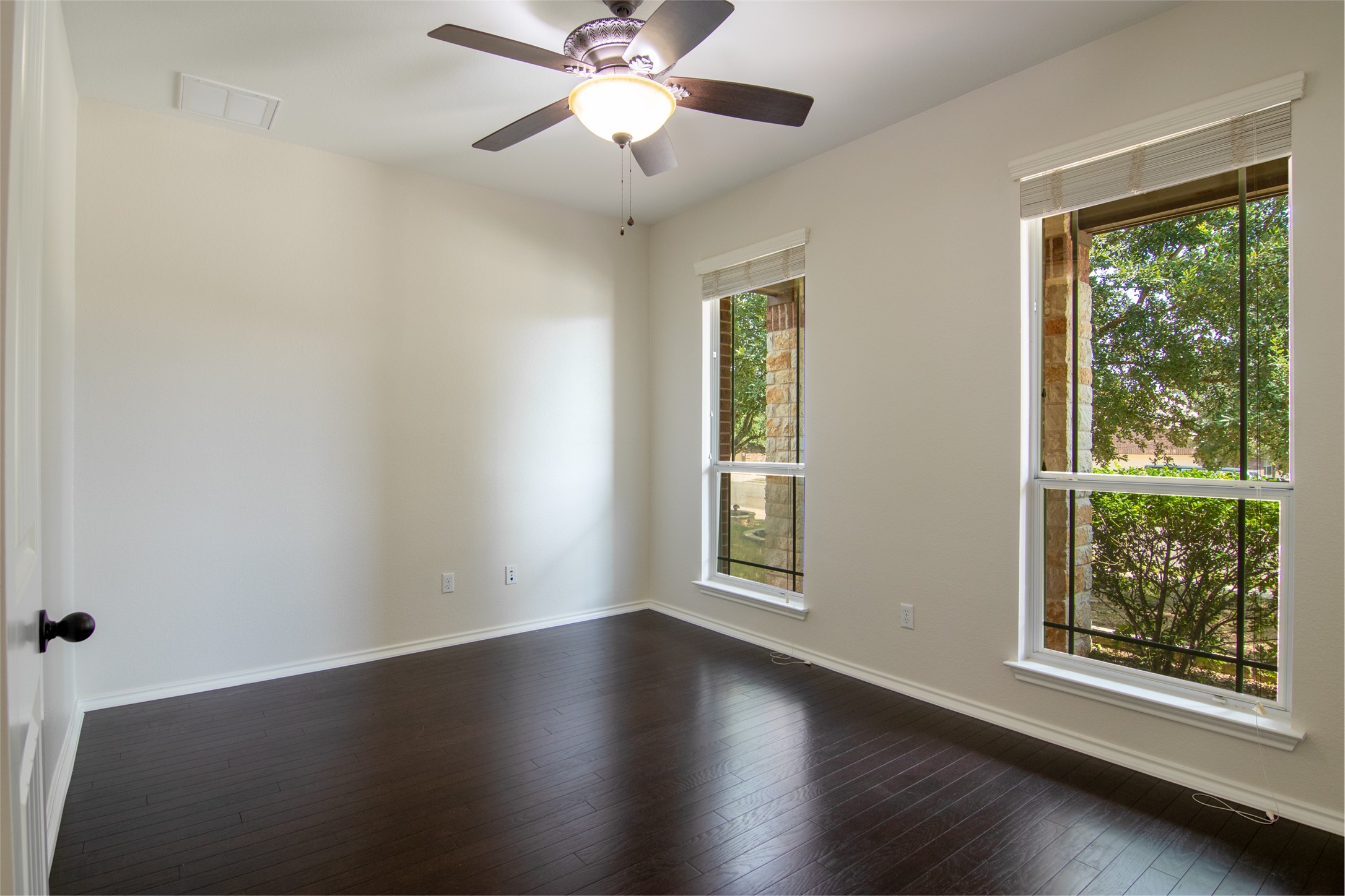 12104 Broten Street Austin, TX 78748 - Photo 15 of 32 Rich hardwood floors complement bright window views in this adaptable room.