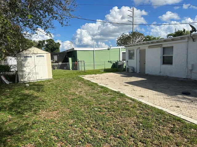 a view of a house with a yard and garage