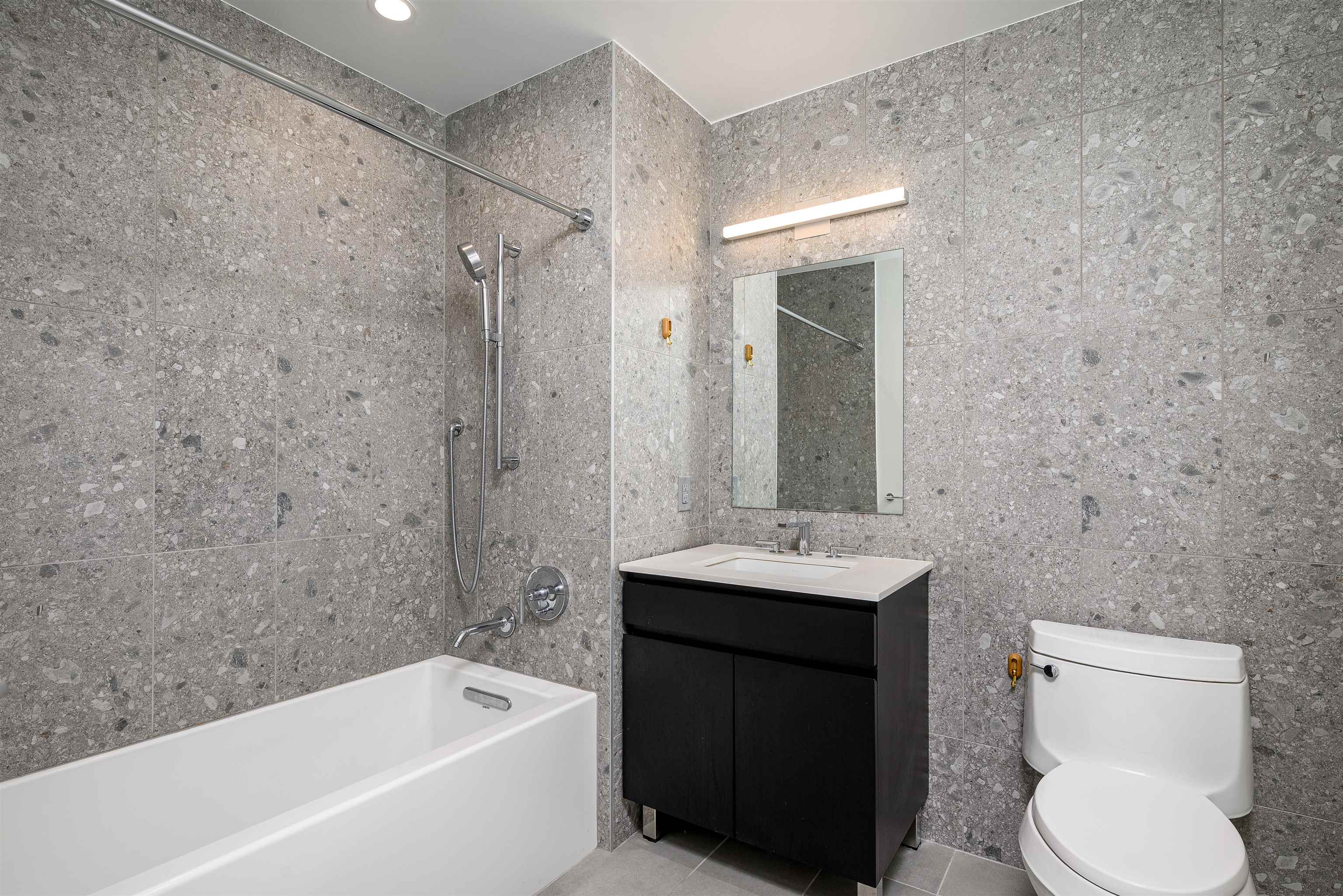 155 Bay Street, Unit R3102 Jersey City, NJ 07302 - Photo 6 of 21 a bathroom with a sink a toilet and shower