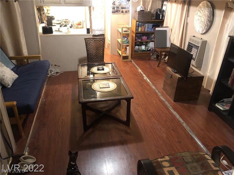 209 Euclid Avenue Goldfield, NV 89013 - Photo 3 of 18 Living room featuring heating unit and dark wood finished floors