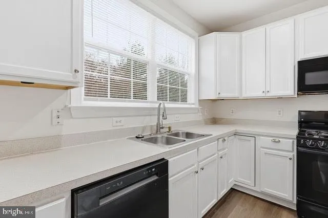 a kitchen with appliances cabinets and a sink