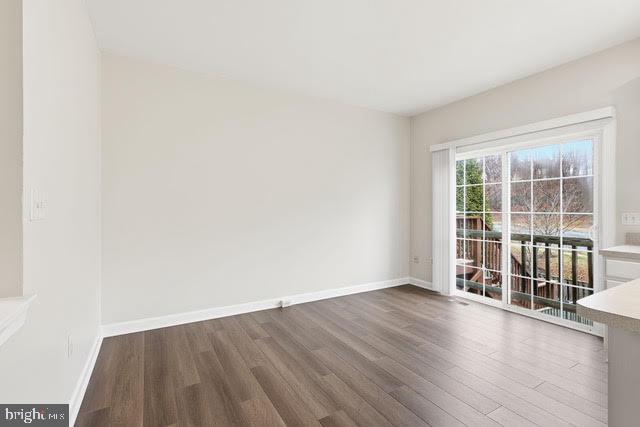 15683 Avocet Loop Woodbridge, VA 22191 - Photo 14 of 38 an empty room with wooden floor and windows