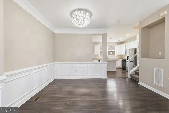 a view of kitchen with cabinets and wooden floor