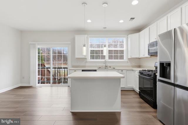 15683 Avocet Loop Woodbridge, VA 22191 - Photo 9 of 38 a kitchen with stainless steel appliances granite countertop a stove and a refrigerator