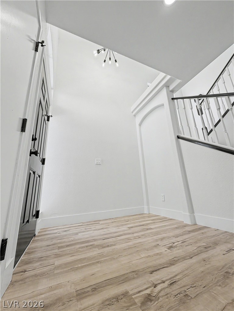 8977 Paige Rene Court Las Vegas, NV 89117 - Photo 27 of 31 A welcoming entryway with a grand staircase and light wood flooring sets a sophisticated tone.