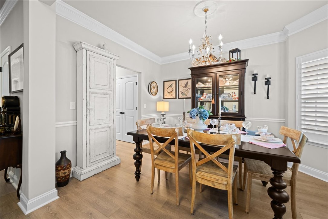119 Shipyard Circle Anderson, SC 29621 - Photo 13 of 50 This formal dining space features luxury vinyl wood flooring, elegant crown molding, and charming lighting.