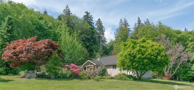 a aerial view of a house with swimming pool garden and trees