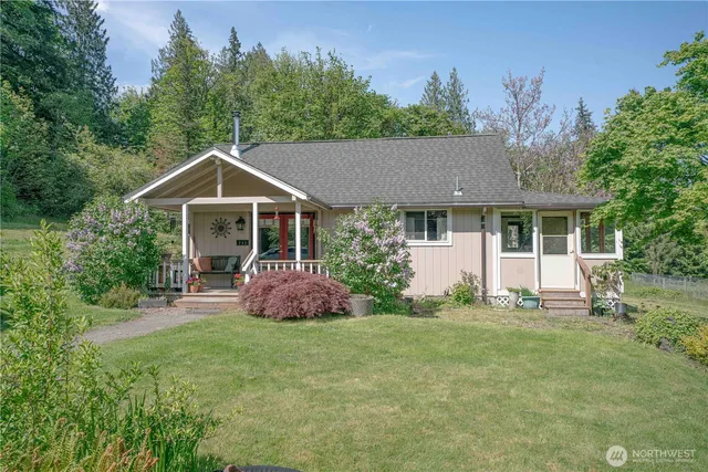 a view of a green field with wooden fence