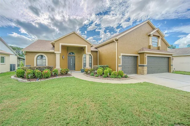 a front view of a house with a yard and garage