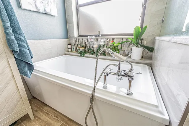 a bathroom with a granite countertop toilet sink double vanity and a mirror
