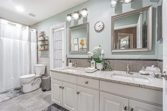 a living room with furniture a flat screen tv and a dining table