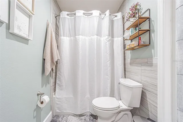 a bedroom with a bed and a lamp