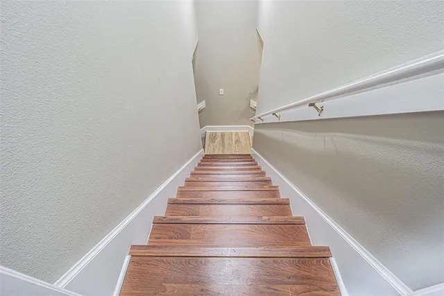 a living room with furniture a flat screen tv and a dining table