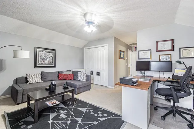 a living room with furniture and a book shelf