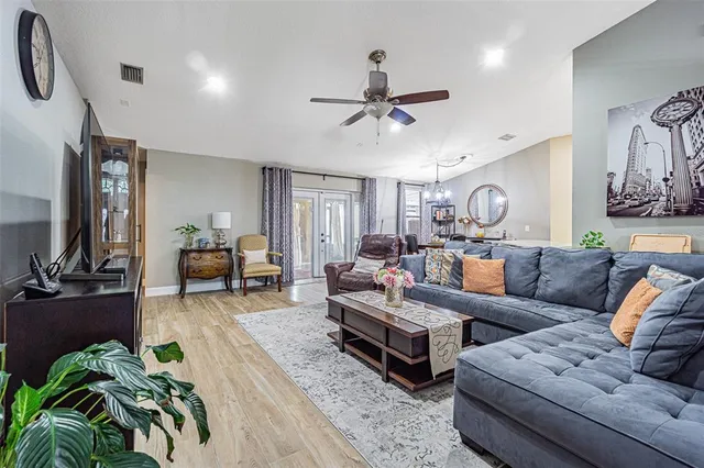 a living room with furniture and a flat screen tv with wooden floor