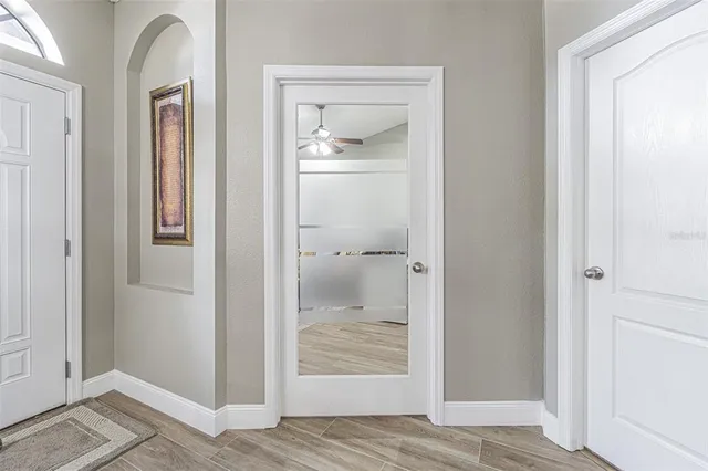 a bathroom with a granite countertop sink a mirror and a shower