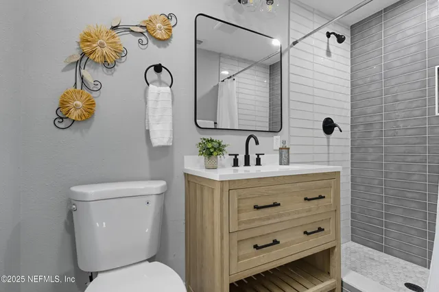 a bathroom with a toilet sink and mirror