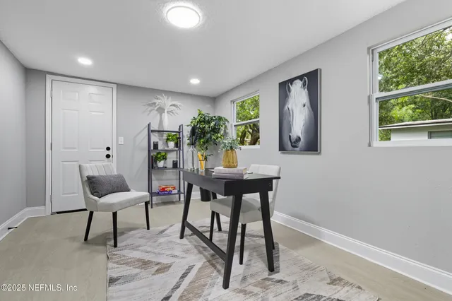 a view of a work space with furniture and window