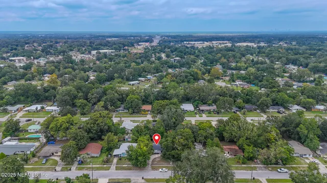 an aerial view of residential house with outdoor space and swimming pool