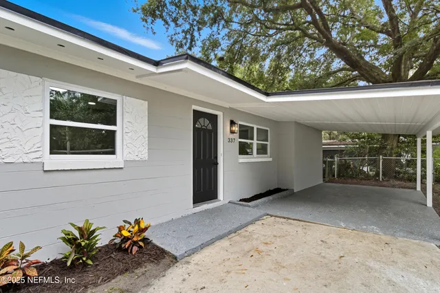 a view of a house with a wooden fence
