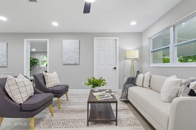 a living room with furniture and a large window