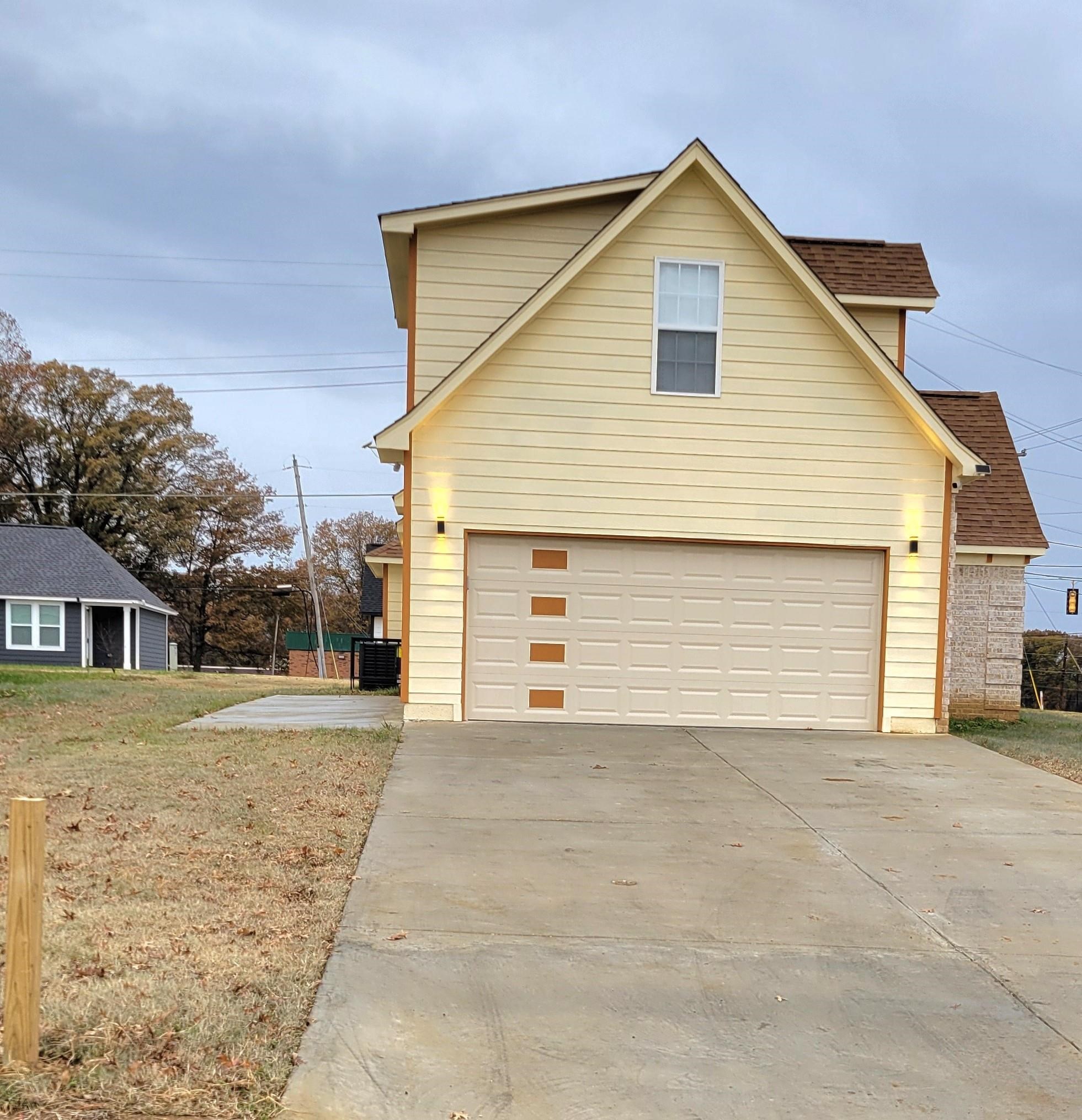 251 East Mitchell Road Memphis, TN 38109 - Photo 2 of 24 View of side of property with a lawn and a garage