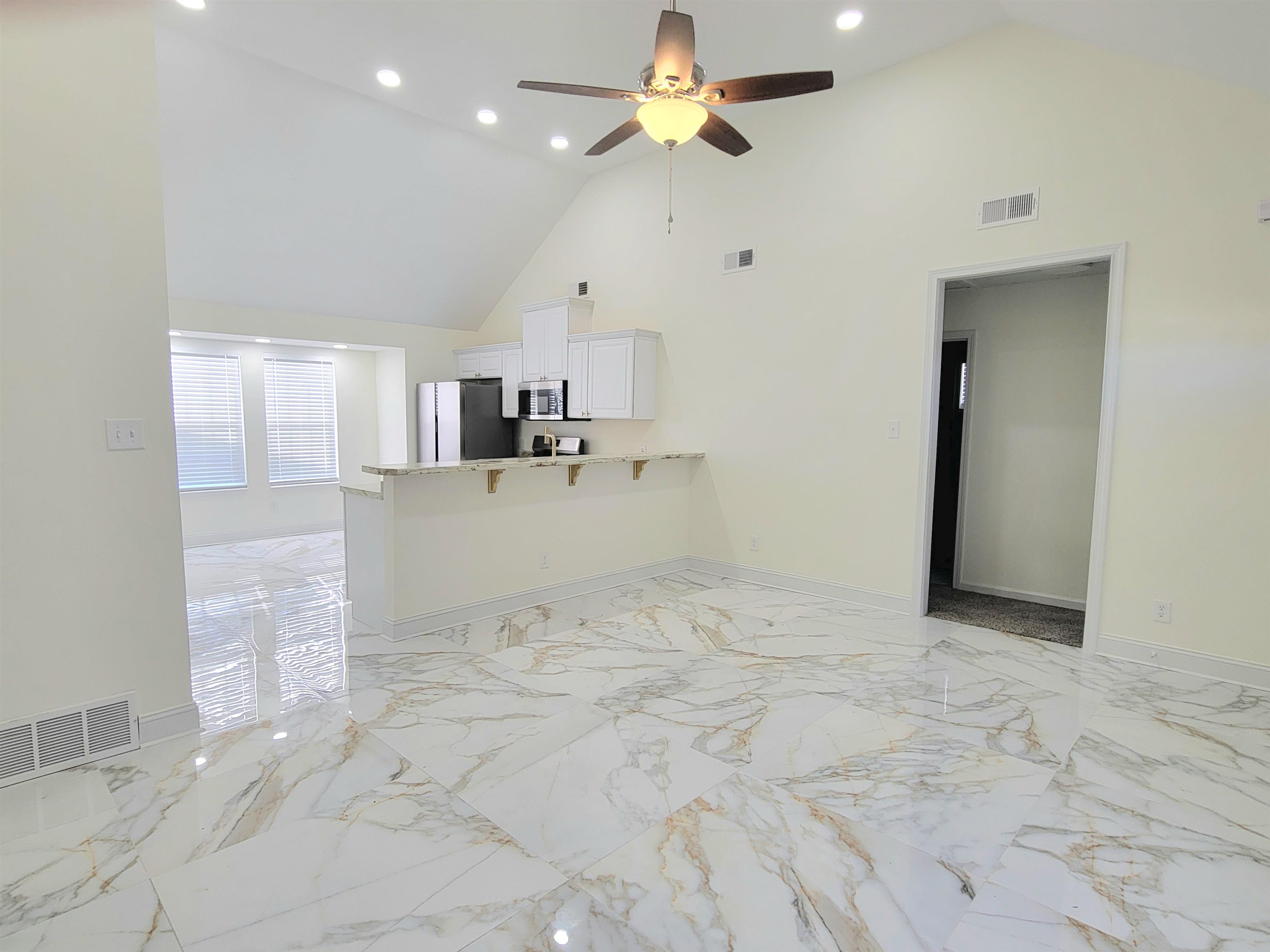 251 East Mitchell Road Memphis, TN 38109 - Photo 3 of 24 Living room with ceiling fan and high vaulted ceiling